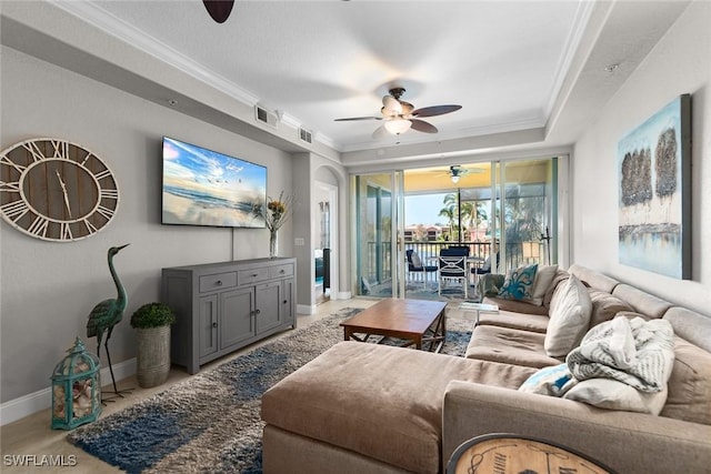 living area with crown molding, ceiling fan, and visible vents