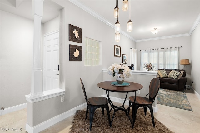 dining space featuring crown molding and decorative columns