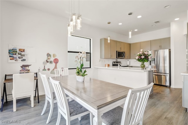 dining area with light hardwood / wood-style flooring