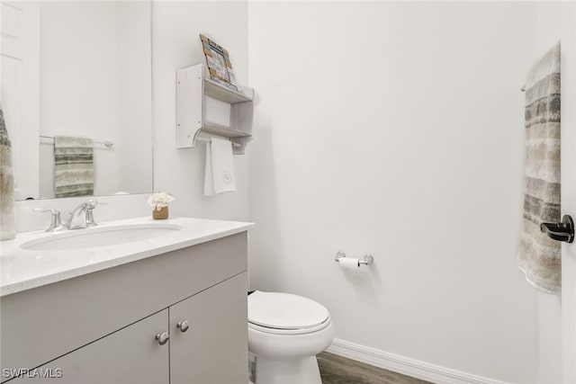 bathroom with vanity, wood-type flooring, and toilet