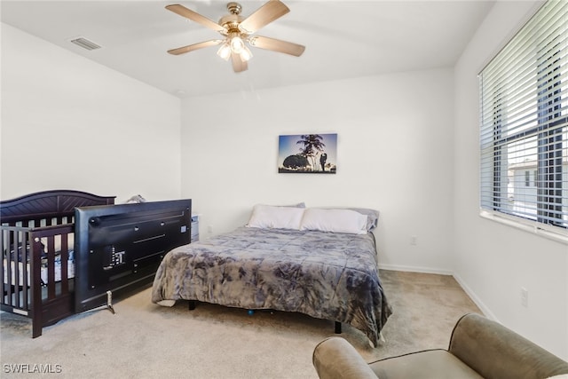 carpeted bedroom with ceiling fan