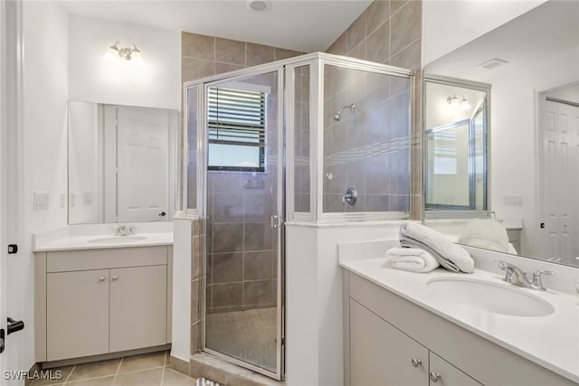 bathroom with tile patterned flooring, vanity, and a shower with door