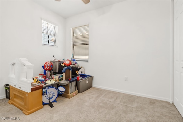 playroom featuring ceiling fan and light carpet