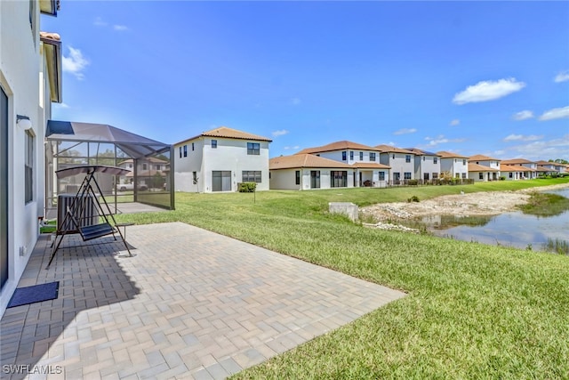 exterior space with a water view and glass enclosure