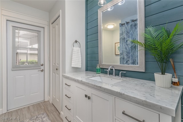 bathroom with hardwood / wood-style floors and vanity