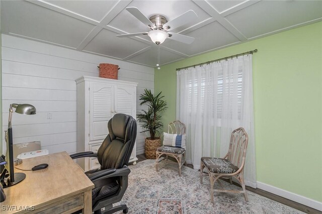 home office with ceiling fan, wood walls, wood-type flooring, and coffered ceiling