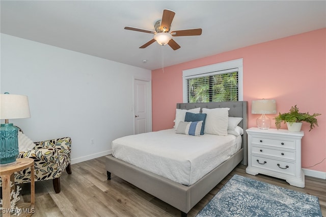 bedroom with ceiling fan and hardwood / wood-style floors