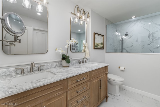 bathroom featuring a tile shower, vanity, and toilet