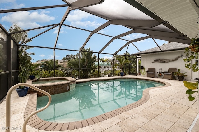 view of swimming pool featuring a lanai, a patio area, and an in ground hot tub