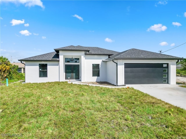 prairie-style home with a front lawn and a garage