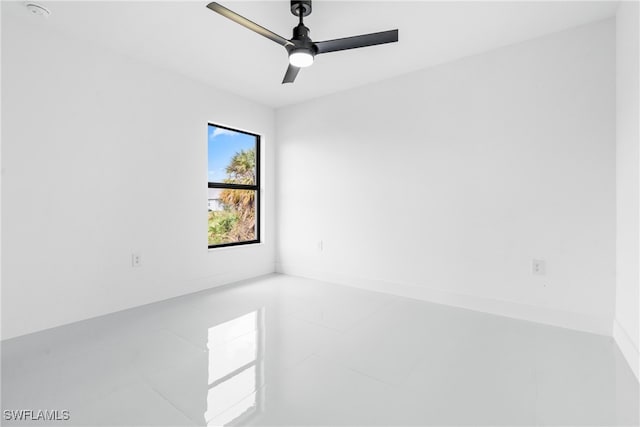 spare room with tile patterned floors and ceiling fan