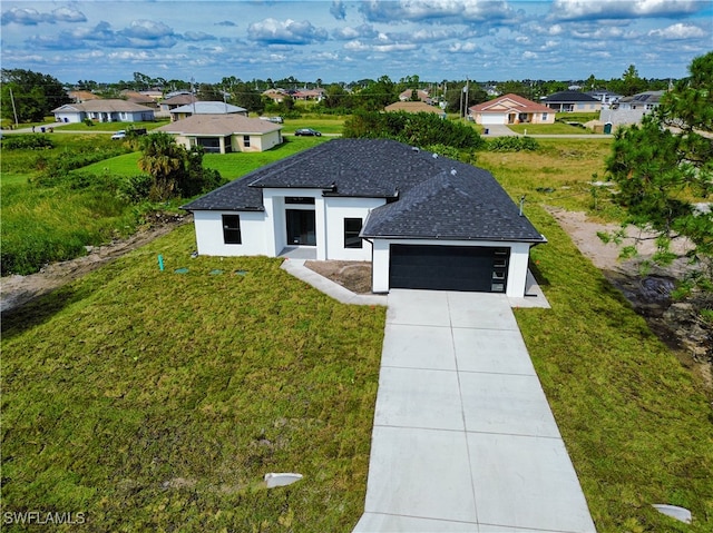 view of front facade with a front yard and a garage