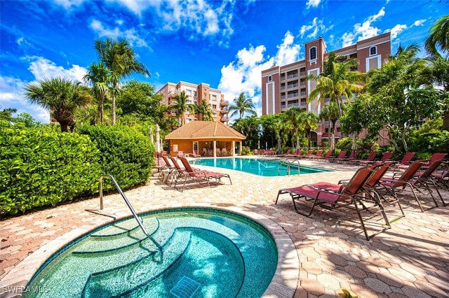 view of swimming pool with a community hot tub and a patio