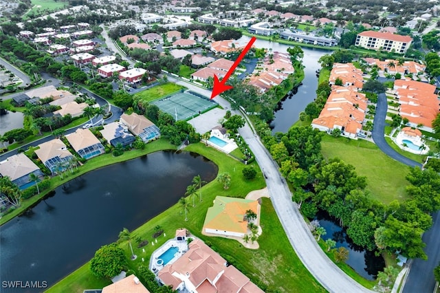 birds eye view of property with a water view