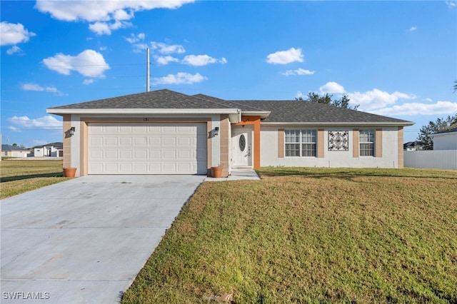 single story home featuring a front lawn and a garage