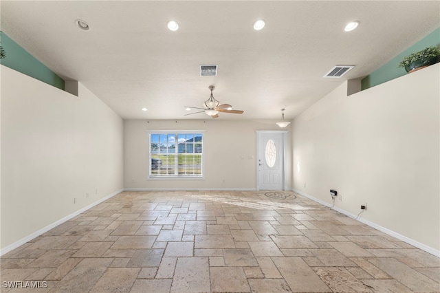 unfurnished living room with ceiling fan