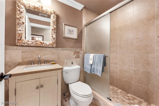 bathroom with vanity, toilet, and tile walls