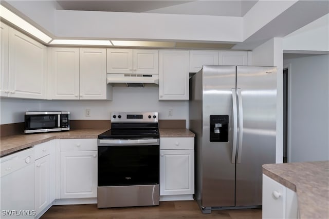 kitchen with white cabinets, stainless steel appliances, and dark wood-type flooring