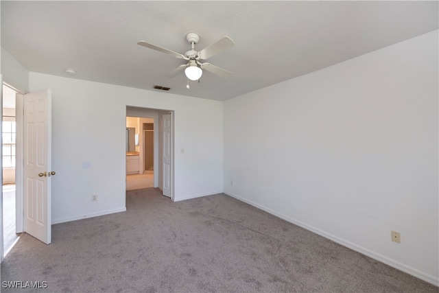 carpeted spare room with ceiling fan