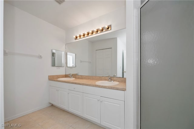 bathroom with vanity, walk in shower, and tile patterned floors