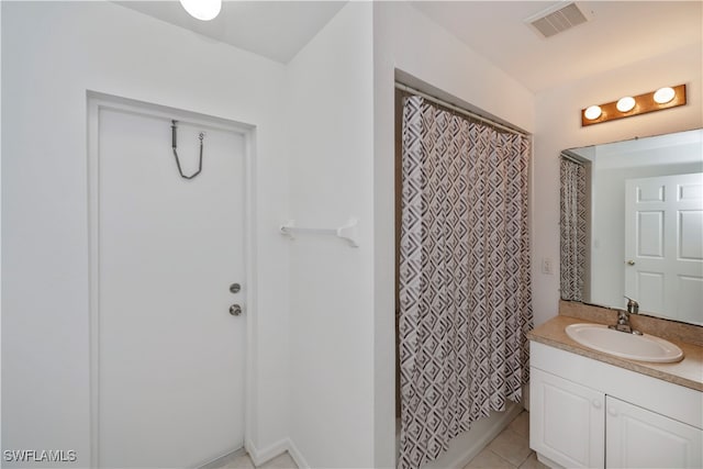 bathroom featuring vanity, walk in shower, and tile patterned floors