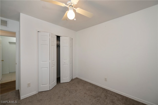 unfurnished bedroom with a closet, carpet, and ceiling fan