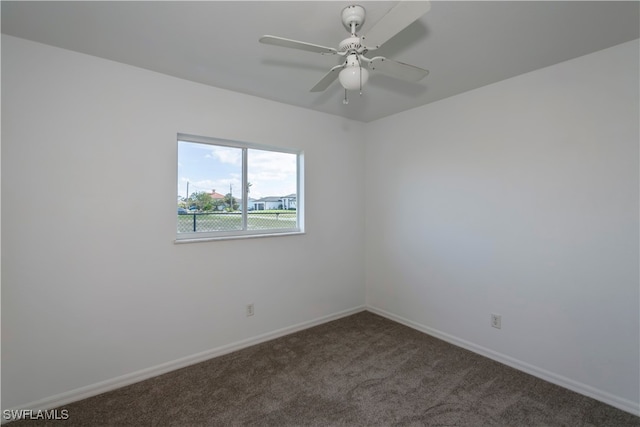 spare room featuring carpet and ceiling fan