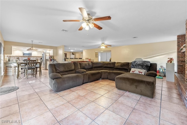 tiled living room featuring ceiling fan