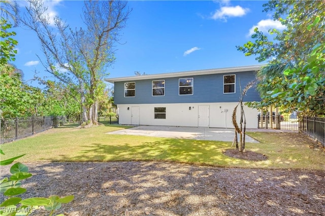 back of property featuring a patio and a lawn