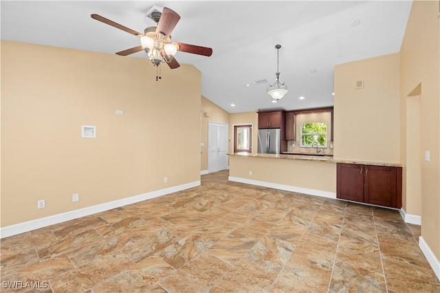 unfurnished living room featuring ceiling fan and lofted ceiling