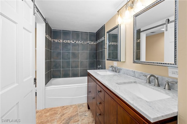 bathroom with tiled shower / bath combo and vanity