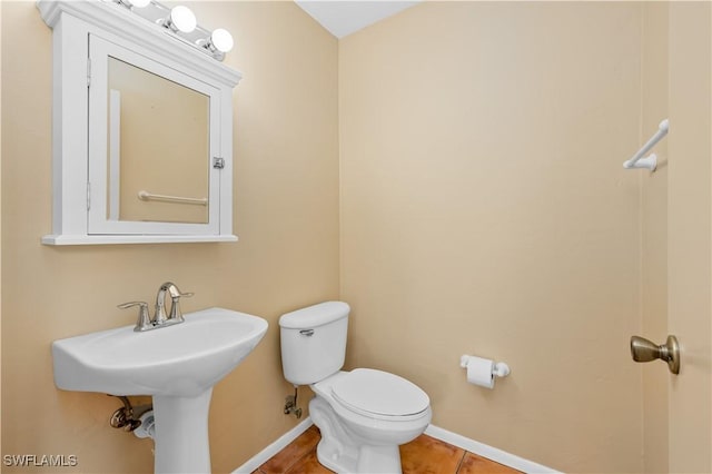 bathroom featuring tile patterned floors and toilet