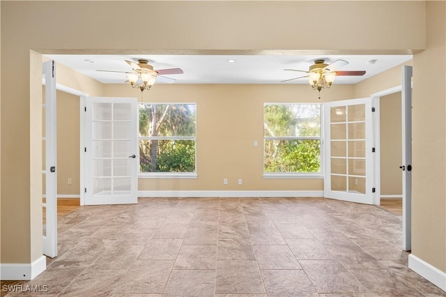 unfurnished room with french doors and ceiling fan