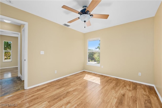 unfurnished room with ceiling fan and light wood-type flooring