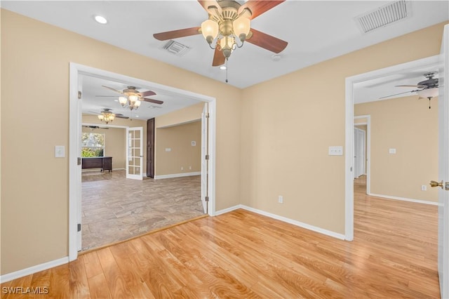 unfurnished room with light hardwood / wood-style floors and french doors