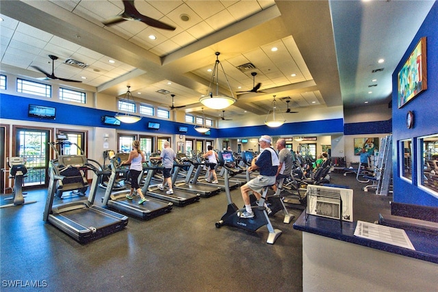 workout area featuring a towering ceiling and ceiling fan