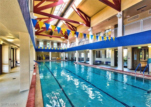 view of swimming pool featuring a skylight