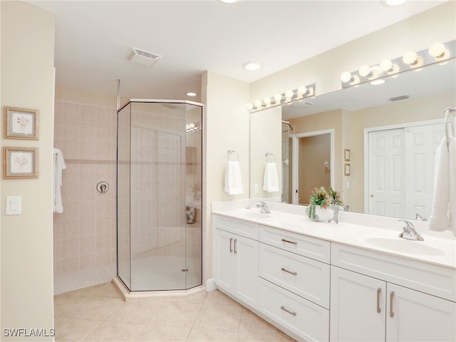 bathroom with vanity, tile patterned flooring, and a shower with door