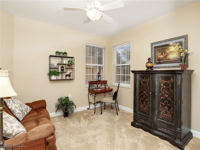 sitting room with ceiling fan and light colored carpet