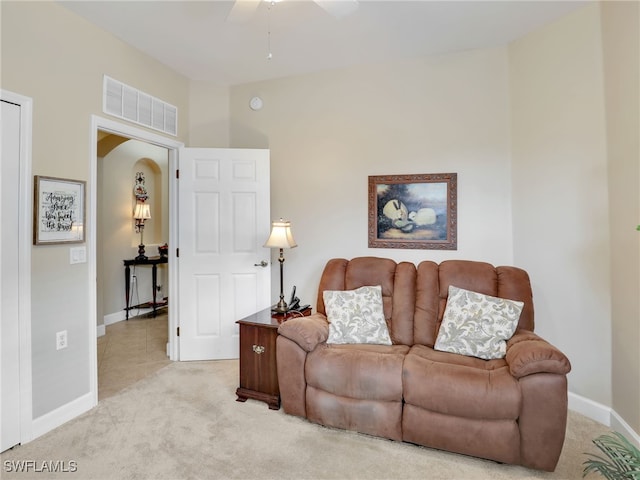 carpeted living room featuring ceiling fan