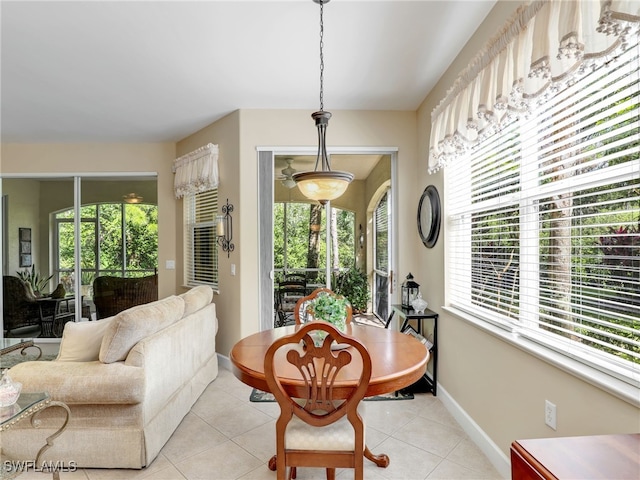 dining area with a wealth of natural light and light tile patterned flooring