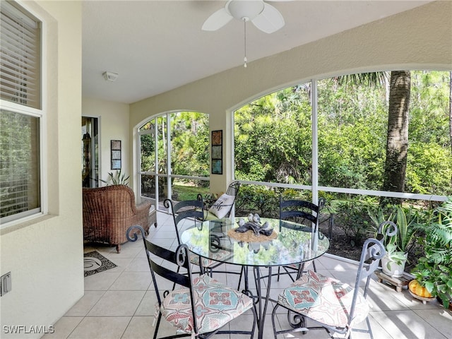 sunroom / solarium featuring ceiling fan