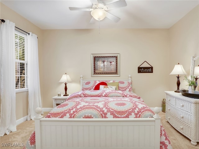 bedroom featuring light colored carpet and ceiling fan