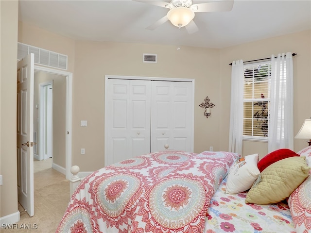 carpeted bedroom featuring a closet and ceiling fan