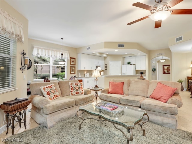 tiled living room with ceiling fan