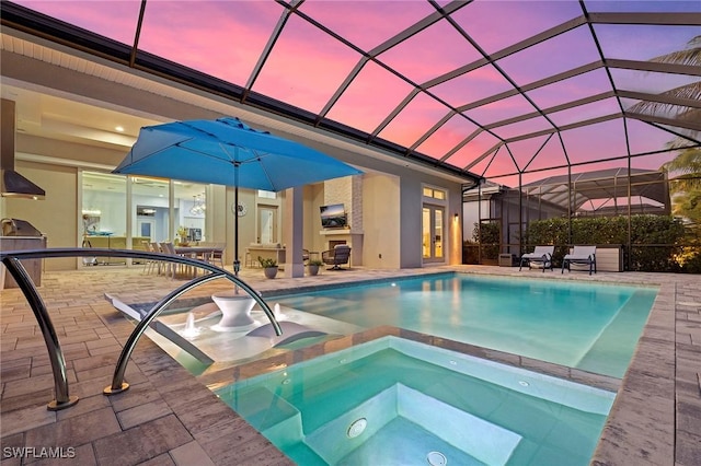 pool at dusk with a patio area, a lanai, and an in ground hot tub