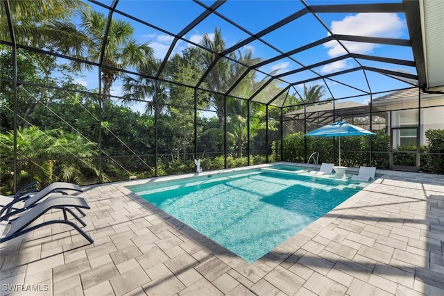 view of pool with a lanai and a patio