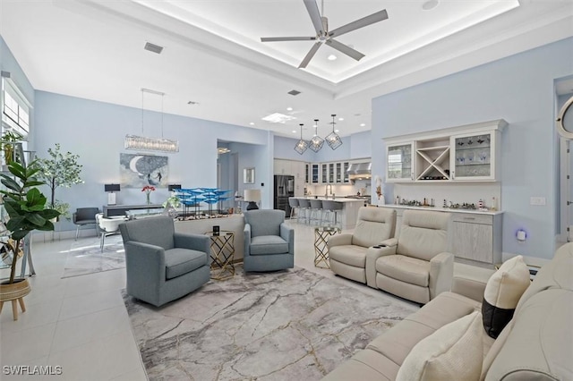 living room featuring ceiling fan and indoor wet bar