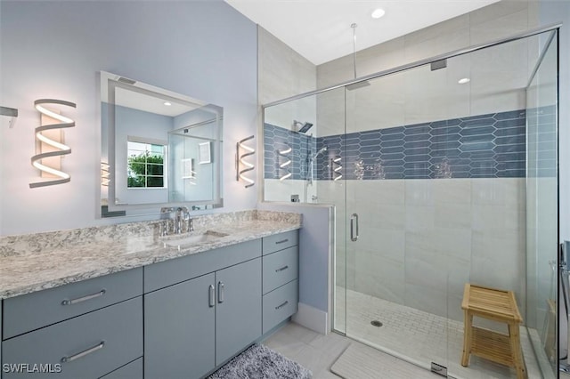 bathroom featuring vanity, tile patterned floors, and a shower with shower door