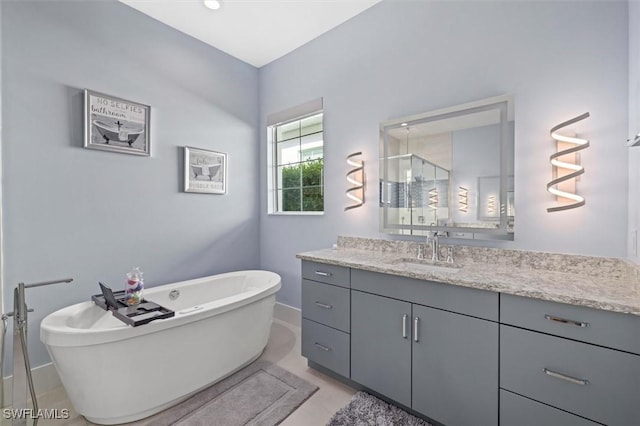 bathroom with vanity and shower with separate bathtub